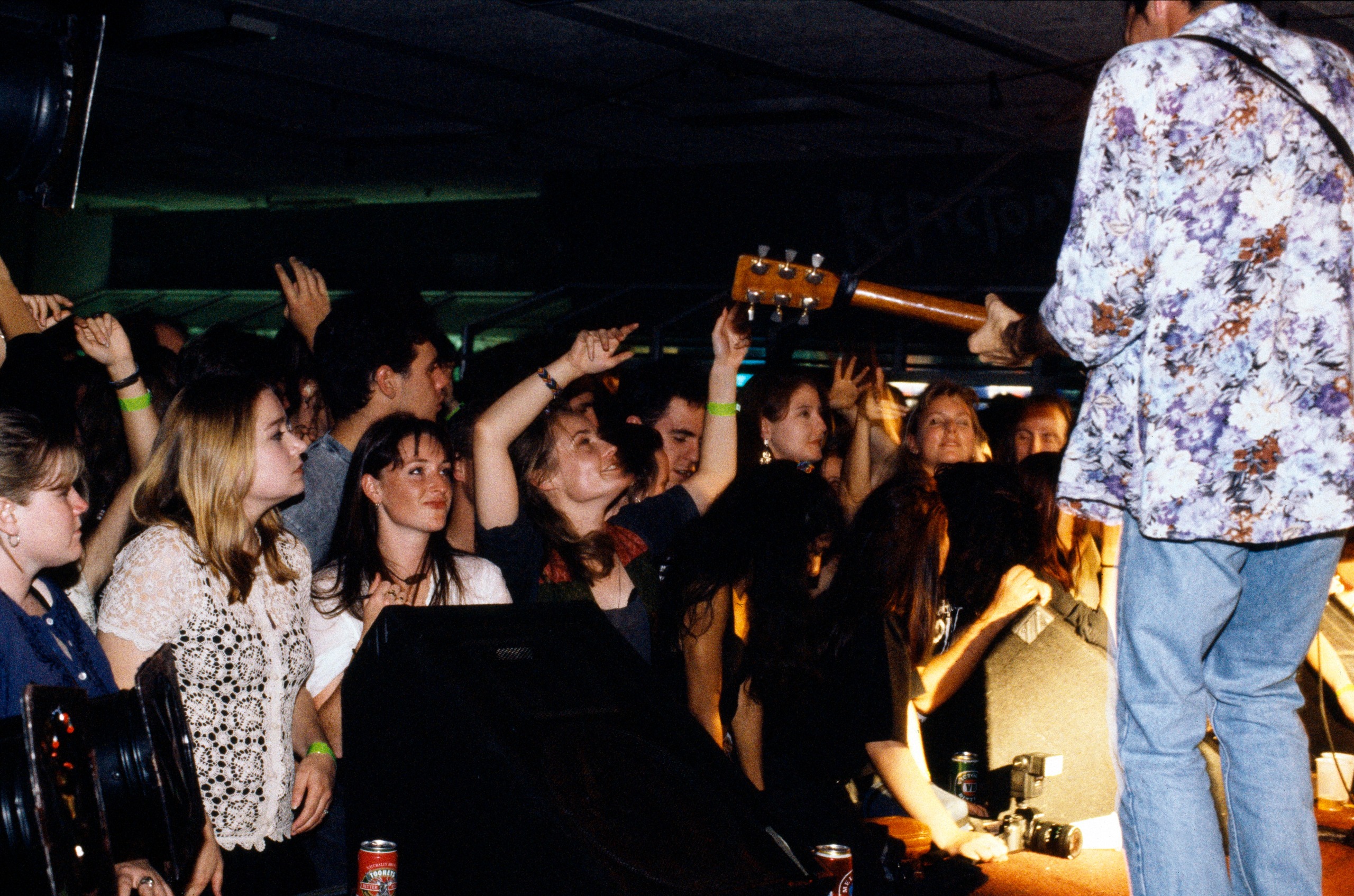 Crowd of people dancing in front of a rock band